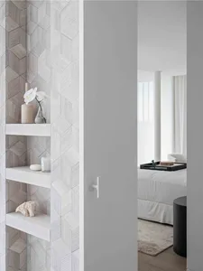 A modern minimalist bedroom with wooden shelving featuring decorative items.