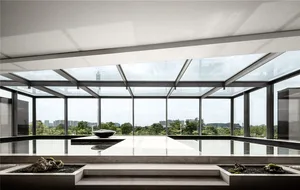 A modern living space with a glass ceiling and a minimalist design.