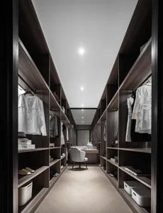 Modern industrial-style closet with wooden shelves and clothing items.