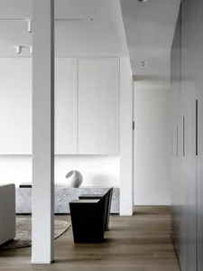 Modern living room featuring white marble accents and wooden flooring