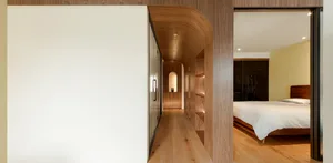 Modern minimalist bedroom featuring a wood cabinet and a cozy ambiance