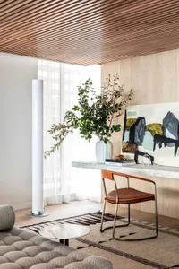 A modern interior design living room with wooden floors, a comfortable sofa, a wooden table, and minimalist decor.