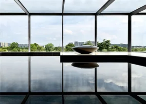 Modern interior space featuring glass walls and concrete elements.