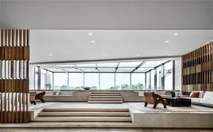 Modern living room with concrete flooring and minimalist furniture.