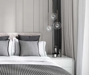 Modern minimalist bedroom featuring textured fabric curtains, a padded textile headboard, and pendant glass lighting fixtures