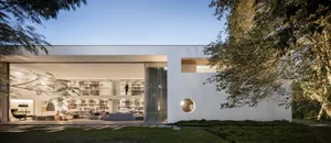 A modern minimalist house with concrete walls and a large open living area.