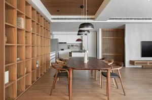 Modern kitchen and dining room with wooden furniture and open shelving.