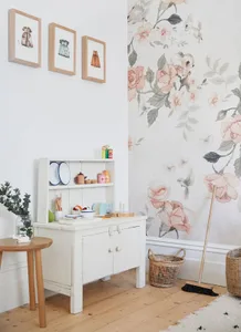 Children's room featuring play furniture made of wood, with toys and paper goods.