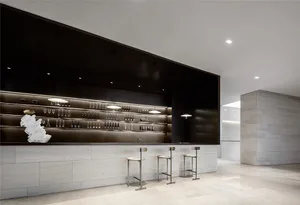 Modern bar counter with concrete finish, showcasing sleek, minimalist design.