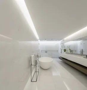 Modern minimalist bathroom with white marble fixtures and a round freestanding bathtub.