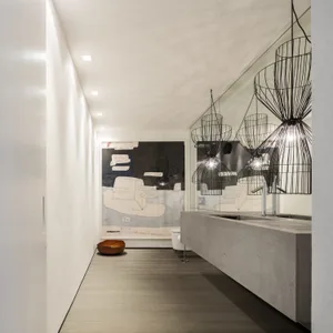 Modern minimalist bathroom featuring concrete and metal materials.