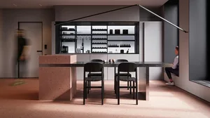 A modern, minimalist kitchen with concrete finishes and sleek design features.
