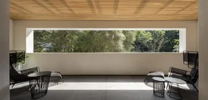 A modern living room with concrete flooring and minimalist furniture.