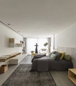 Modern minimalist bedroom with a bed, lamp, and chair near a large window.