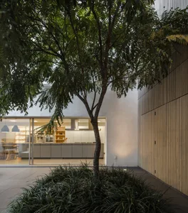 A modern minimalist urban retreat featuring a living room with concrete and steel materials.