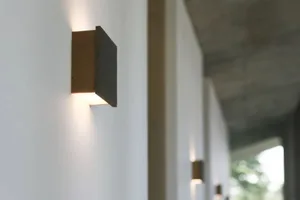 Metal wall light fixture with a minimalist design.