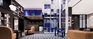 A modern hotel lobby featuring glass and metal elements.