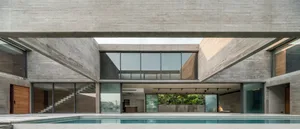 Modern house exterior with a concrete facade and a pool.