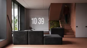 Modern living room with concrete floors, grey furniture, and a large window