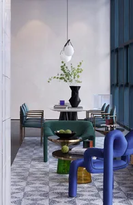 Modern minimalist living room featuring metal, leather, and glass furniture on a patterned floor.