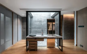 A minimalist office suite featuring concrete elements and a sleek, modern design.