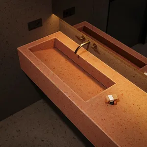 Modern bathroom with concrete sink and brass faucet.