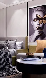 A beautifully styled modern minimalist living room featuring elegant white furniture, gold accents, and a striking butterfly 
