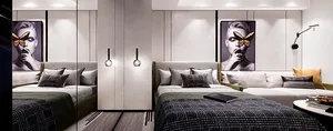 Modern bedroom with black and white decor, including a bed with grey and white bedding and a sofa with similar color scheme, 