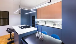 A modern kitchen with blue countertops, featuring sleek, minimalist design elements and a clean, uncluttered aesthetic.