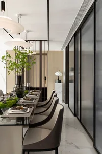 Contemporary dining room with glass tables and leather chairs