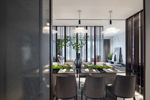 A modern dining room featuring metal, glass, and wood materials, with a long dining table set for a meal.