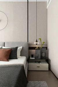 Modern bedroom featuring a bed with a textured headboard and pendant lighting hanging above.