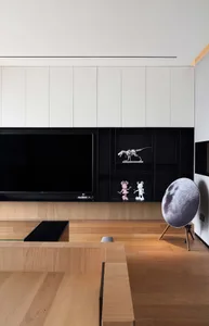 Modern interior design featuring black, white, and wooden elements in a living room setting.
