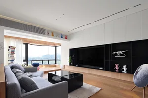 Modern living room with a wooden sofa, coffee table, and decorative items.