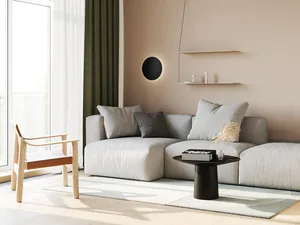 Modern minimalist living room with light-colored fabric sofa, wooden armchair, and round coffee table.