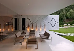 A modern minimalist interior space featuring concrete and glass materials.