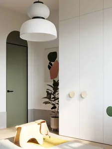 Minimalist bedroom with white furniture, modern design elements, and a white pendant lamp.