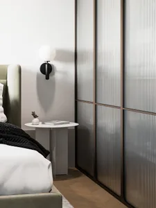A modern bedroom featuring glass panel walls and a minimalist bed setup.