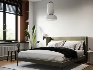 A modern minimalist bedroom featuring a leather bed, white pillows, black blanket, and a white lamp.