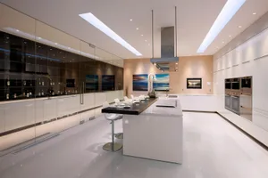 Modern kitchen with marble countertops and minimalist design.