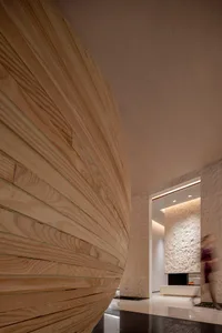 Modern lobby interior with textured wooden walls and a sleek, contemporary design.