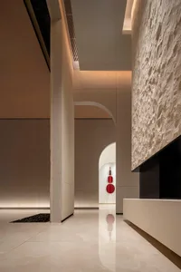 A modern lobby with concrete walls and marble floors.