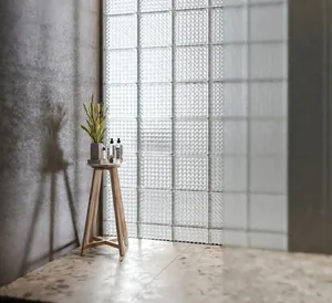 A minimalist bathroom featuring marble flooring and glass tiles.