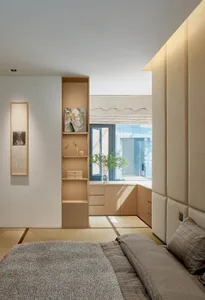 A minimalist bedroom with a storage system, tatami mats, and soft lighting