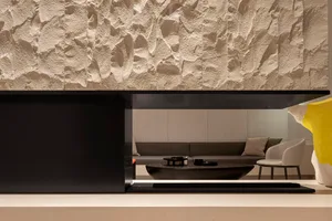 Modern living room with concrete textured walls and minimalist furniture.