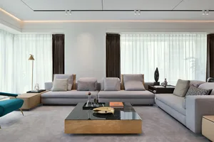 Modern living room featuring fabric couches and white curtains, with a focus on contemporary design elements.