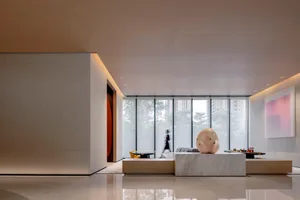 A modern lobby featuring minimalist design elements with glass walls.