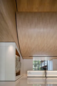 Modern lobby interior featuring wooden paneling and modern design.