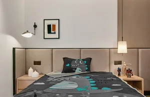 A modern bedroom with a brown padded headboard, a dinosaur-patterned blanket, and a framed abstract painting on the wall.