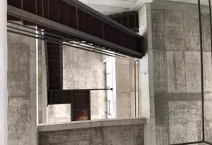 A modern concrete and steel staircase with a metal handrail.